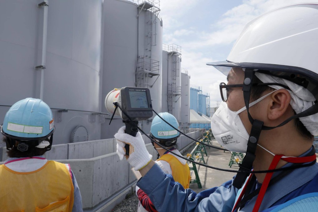 A staff member of Tokyo Electric Power Company measures radiation levels around the storage tanks of radiation-contaminated water at the tsunami-crippled Tokyo Electric Power Company (TEPCO) Fukushima Dai-ichi nuclear power plant in Okuma, Fukushima prefecture, Japan. Photo: AFP/Pool