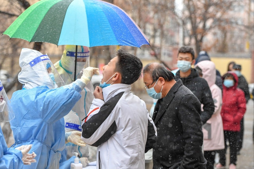 In Jilin City, a medical worker takes a swab sample from a resident for nucleic acid test. Photo: Xinhua