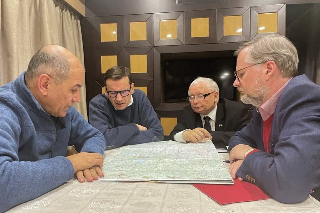 (From left) Slovenian Prime Minister Janez Jansa, Polish Prime Minister Mateusz Morawiecki, leader of the governing Law and Justice (PiS) party Jaroslaw Kaczynski and Czech Prime Minister Petr Fiala talk over a map in a train to Kyiv, Ukraine on Tuesday. Photo: Mateusz Morawiecki via Twitter/EPA-EFE