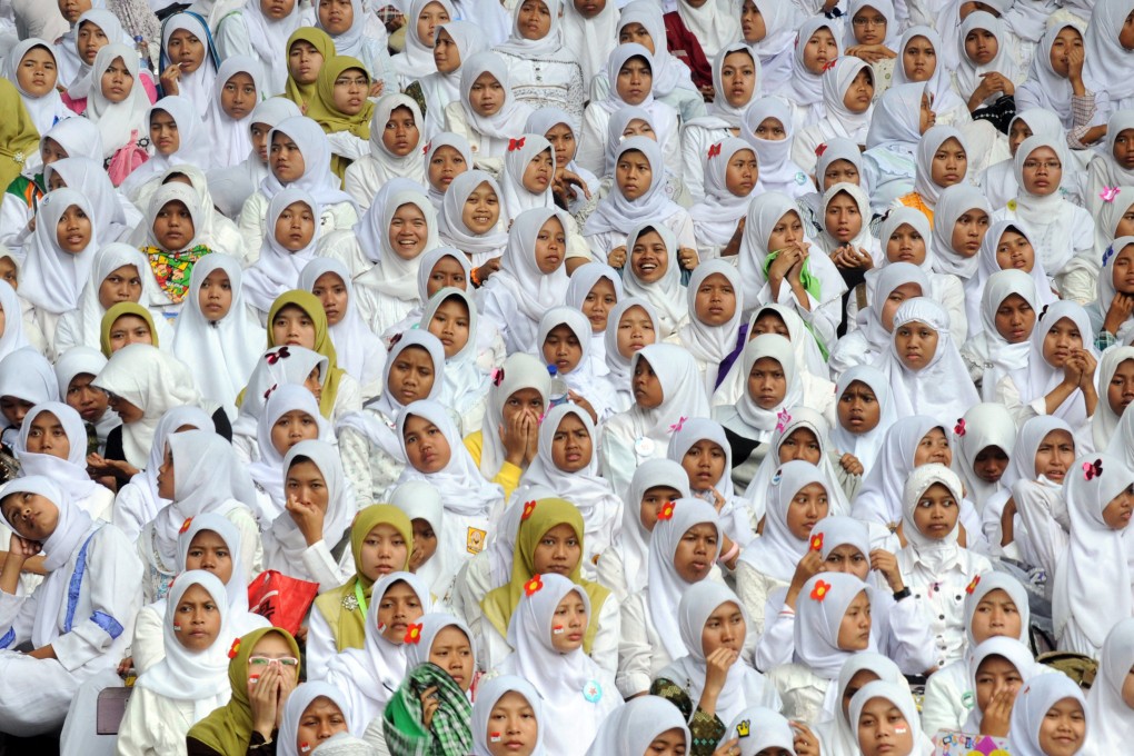 Young women at an anniversary ceremony of the Nahdlatul Ulama organisation at a stadium in Jakarta, Indonesia. Photo: AFP