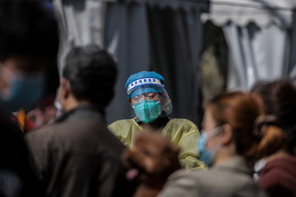 A medical worker is seen at a Covid-19 mass testing venue in a Shanghai park on March 15. Chinese authorities need to make every effort to contain the latest surge in cases. Photo: EPA-EFE