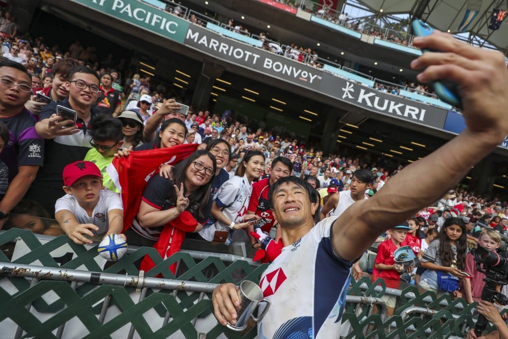 Salom Yiu Kam-shing of Hong Kong takes a selfie with fans after the men’s qualifier final against Ireland on the last day of the 2019 Hong Kong Sevens at Hong Kong Stadium. Photo: Sam Tsang
