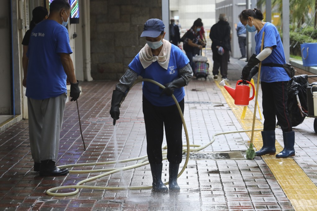 Cleaners spray an open area in Lai King Estate on October 29, 2020. Climate change means water is an ever more precious resource. Photo: Dickson Lee