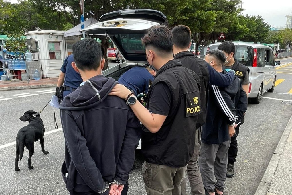 Police arrest two men during an anti-narcotics operation near the Central Ferry Pier on Wednesday. Photo: SCMP Pictures