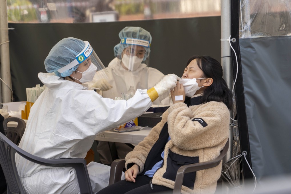 A medical worker takes a swab sample from a woman for Covid-19 test in Seoul, South Korea, on Wednesday. Photo: Xinhua