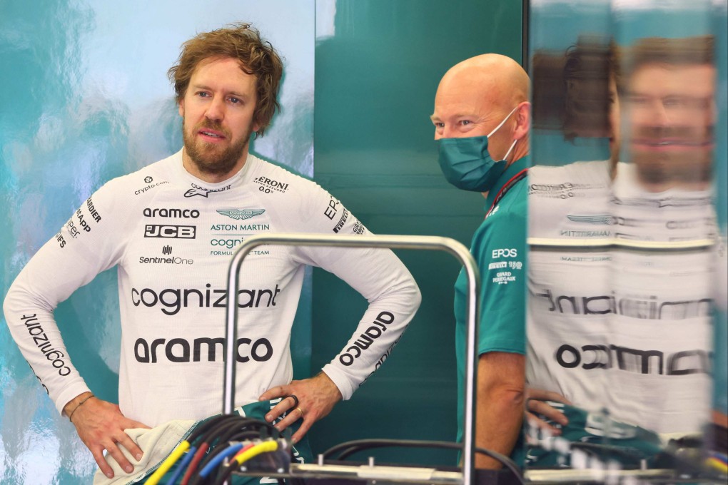 Aston Martin’s driver Sebastian Vettel (left) speaks with a team member during the second day of F1 pre-season testing in Bahrain. Photo: AFP