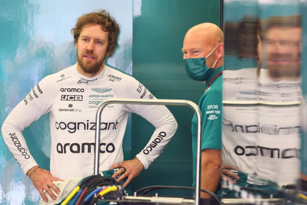 Aston Martin’s driver Sebastian Vettel (left) speaks with a team member during the second day of F1 pre-season testing in Bahrain. Photo: AFP