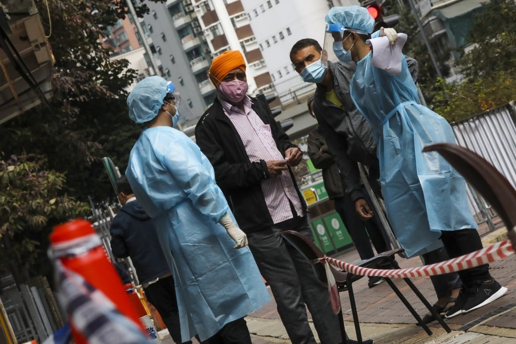 Health workers direct residents to a mandatory Covid-19 testing station after a spike in cases in Jordan and Yau Ma Tai last year. Photo: K. Y. Cheng
