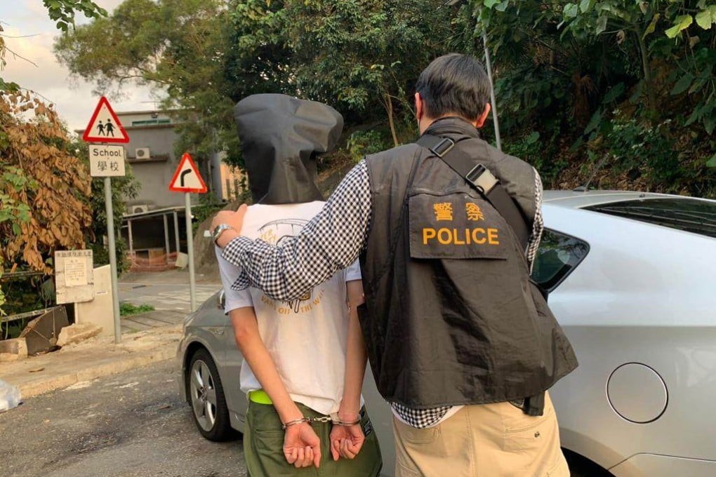 Officer arrests a 27-year-old man on suspicion of throwing faeces inside an isolation facility for Covid-19 patients. Photo: Handout