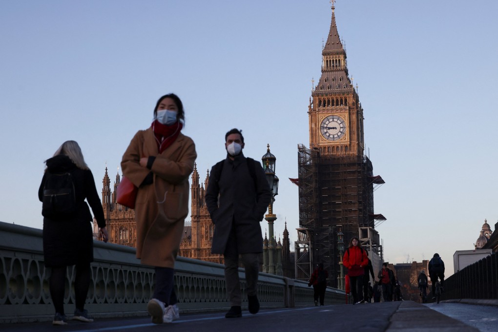 The Houses of Parliament seen as people walk over Westminster Bridge during sunrise in London on January 12, 2022. Photo: Reuters