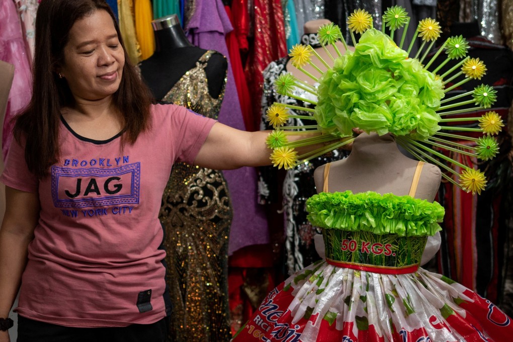 Nora Buenviaje, a dress maker, shows an outfit made of recycled rice sacks, plastic bags and straws at her shop in the Philippines. Photo: Reuters