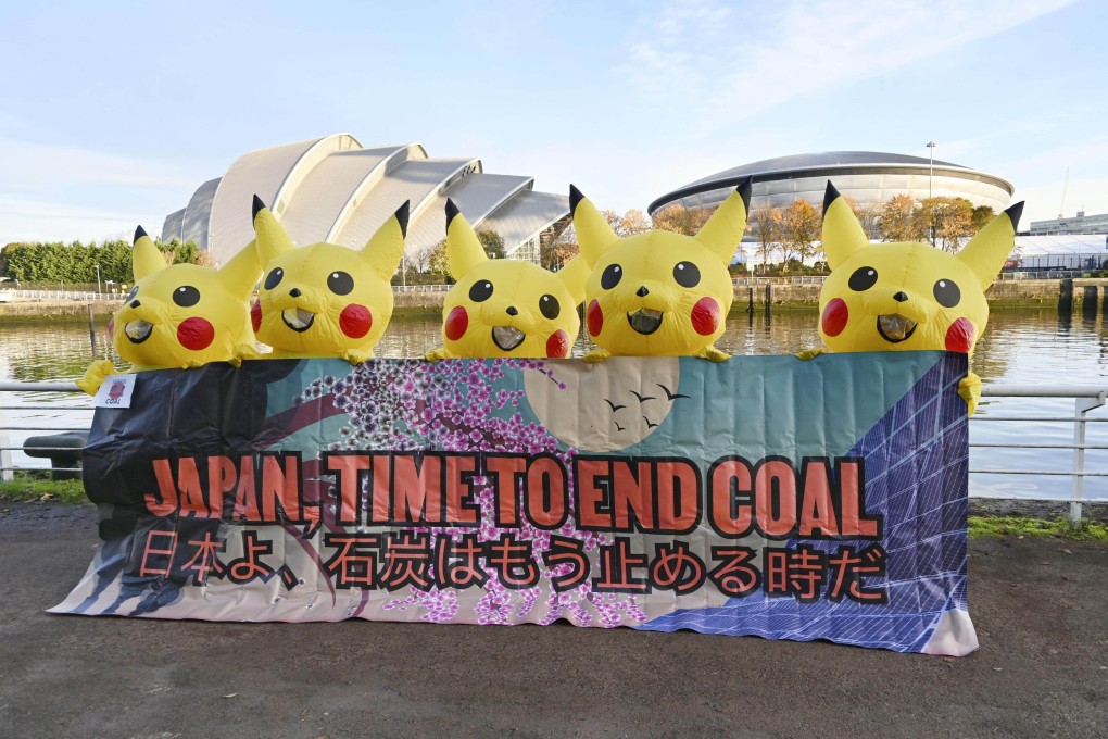 COP26 activists in Glasgow dressed as Pikachu call for Japan to stop using coal-fired power on November 4. Adopting biomass will hurt Japan’s coal phase-out. Photo: Kyodo