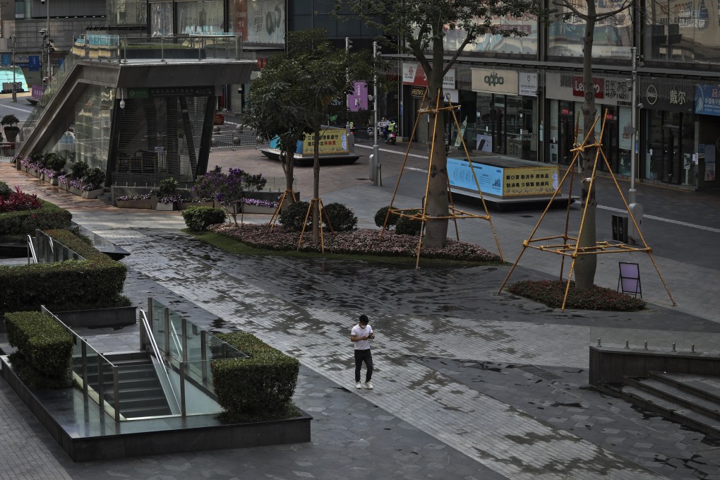 A man wearing a face mask to help protect from the coronavirus walks through a deserted pedestrian street in Huaqiangbei, the world’s biggest electronics market, in Shenzhen’s Futian district, which remains under lockdown through March 20. Photo: AP