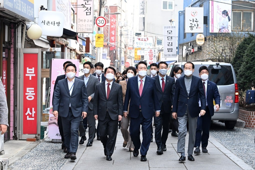 South Korean President-elect Yoon Suk-yeol, centre, takes a stroll with his transition committee members in Seoul on Wednesday. Photo: Yonhap via EPA