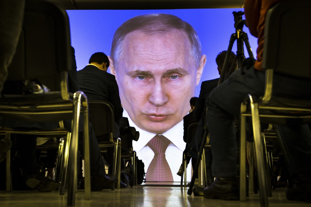 Journalists watch as Russian President Vladimir Putin gives a speech in Moscow in March 2018. Photo: AP