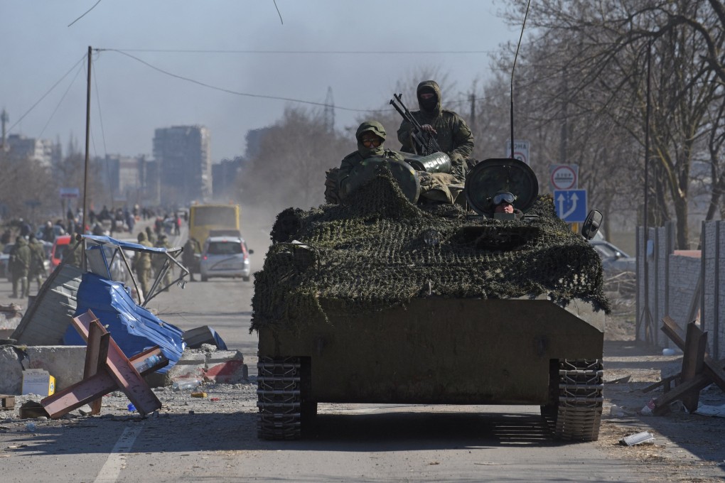 Service members of pro-Russian troops drive an armoured vehicle in Mariupol, Ukraine, on Saturday. Photo: Reuters