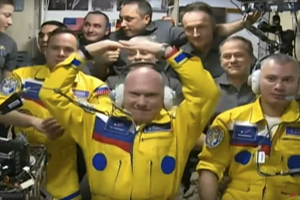 Wearing yellow suits, Russian cosmonauts Оleg Аrtemiev, centre, Denis Мatveev, right, and Sergei Korsakov after docking the Soyuz MS-21 spaceship to the International Space Station on March 18. Photo: Roscosmos Space Agency via AP