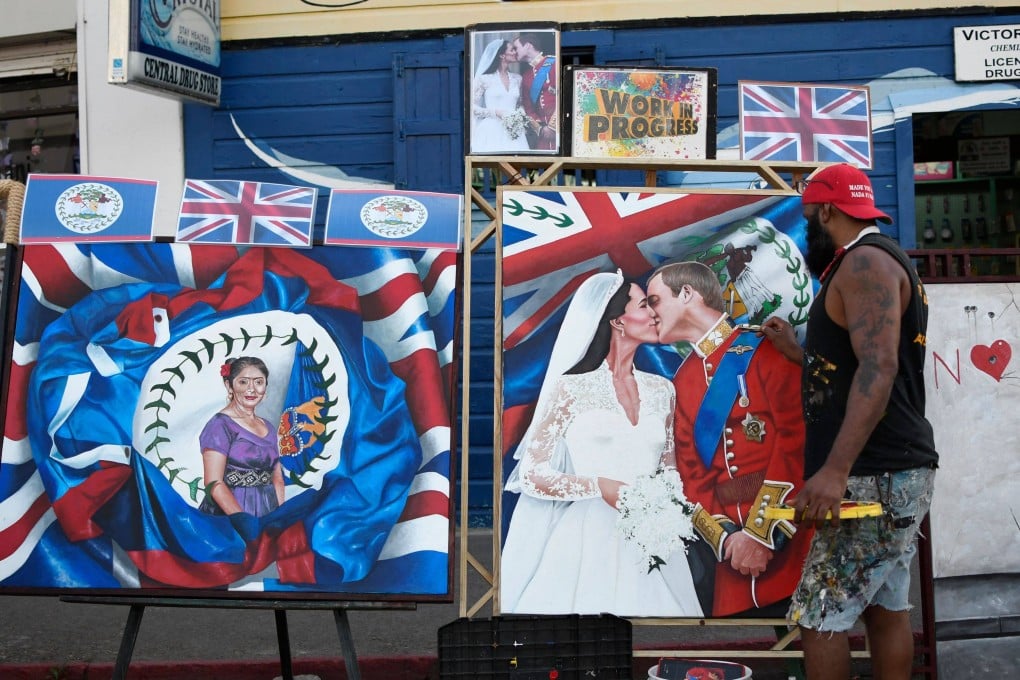 Artist Alex Sanker paints a picture of Britain’s Prince William and his wife Catherine in a street of Belize City ahead of the royals’ visit. Photo: AFP