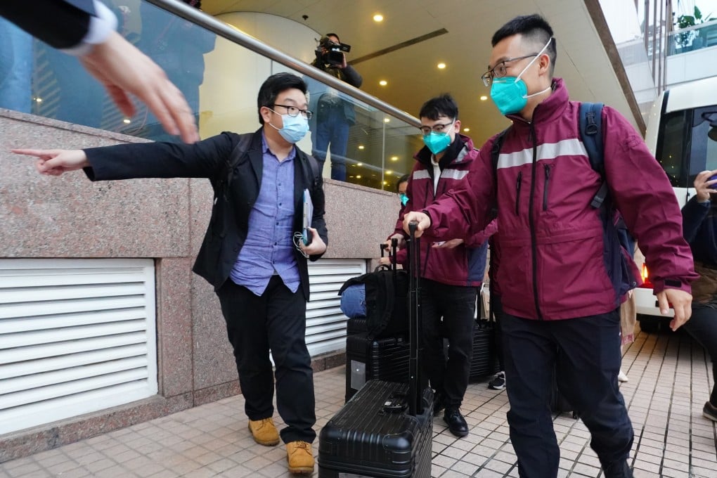 Medical experts, including Kang Min (right), head of the infectious disease institute under the Guangdong Provincial Centre for Disease Control and Prevention, arrive at The Gateway in Tsim Sha Tsui, in Hong Kong, on February 17. Photo: Felix Wong