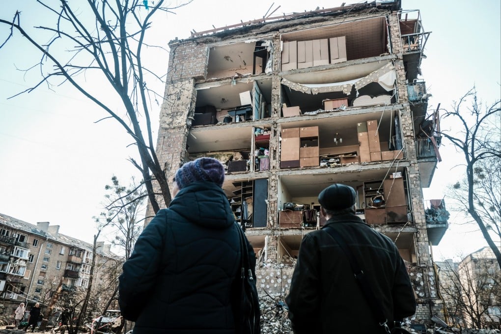 Residents look at a destroyed apartment building after Russian shelling in a neighbourhood in Kyiv on Saturday. Photo: dpa