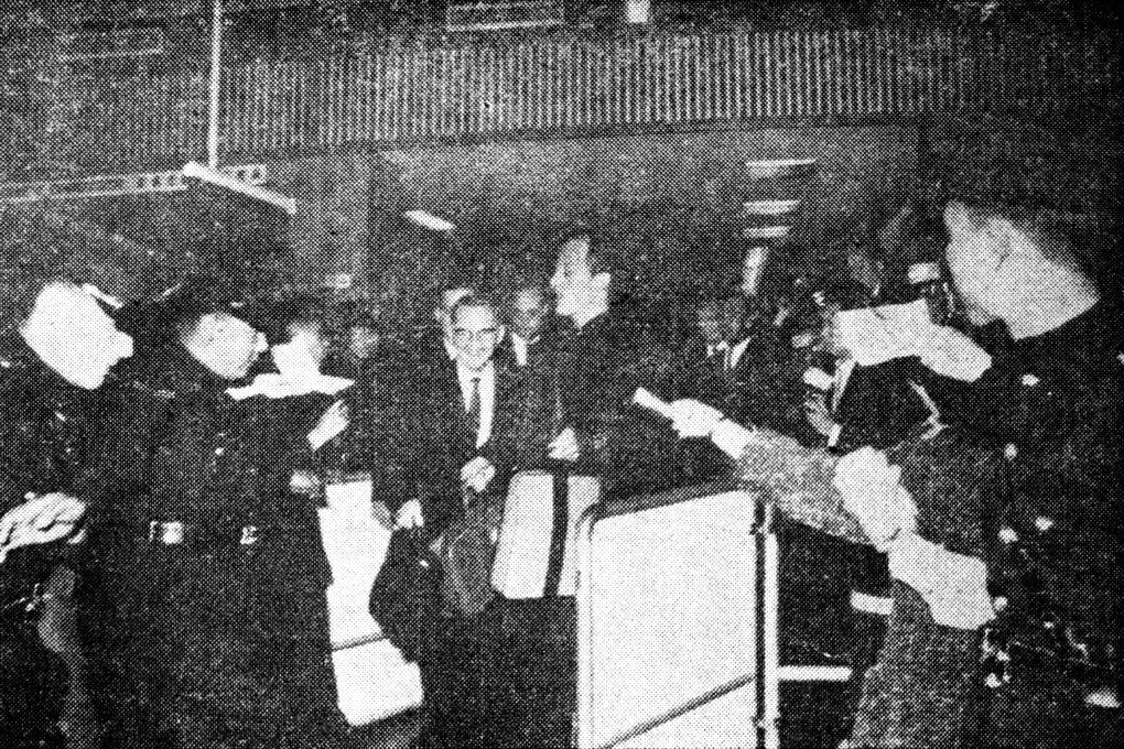 Crowds of excited fans follow Pat Boone (centre) as he exits the customs enclosure at the Kai Tak Airport in March,1964. The singer performed two concerts at City Hall.