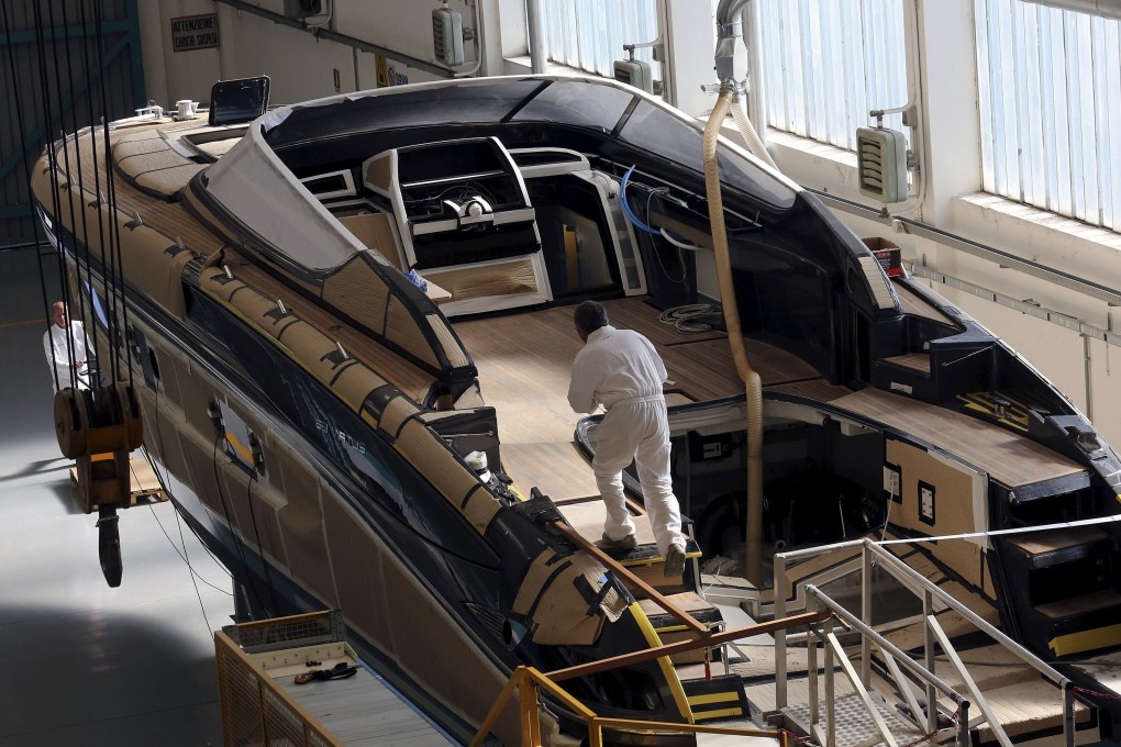 Employees work on a yacht at Ferretti’s shipyard in Sarnico, northern Italy. Photo: Reuters