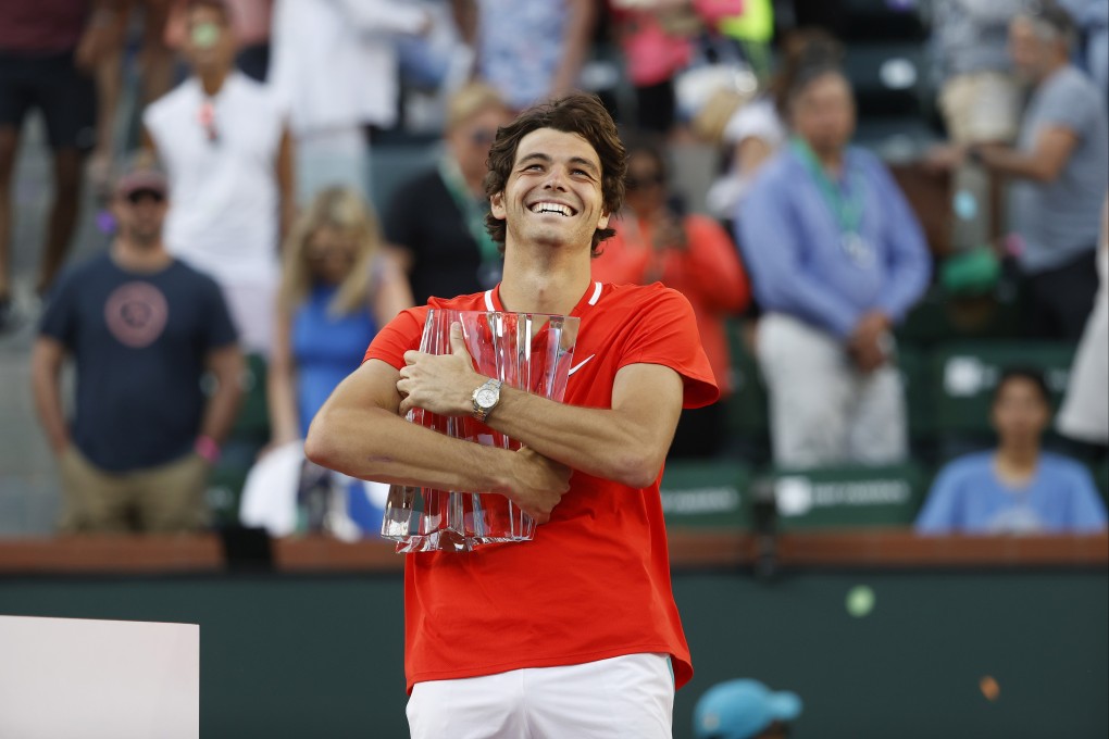 Taylor Fritz celebrates with the championship trophy after beating Rafael Nadal  in the men’s final of the BNP Paribas Open at  Indian Wells. Photo: EPA-EFE
