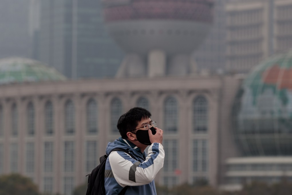 A man wearing a mask for protection walks on the Bund, in Shanghai, China. On Saturday, China reported 2,157 locally transmitted Covid-19 cases and 1,713 asymptomatic infections, according to the National Health Commission. Photo:EPA-EFE