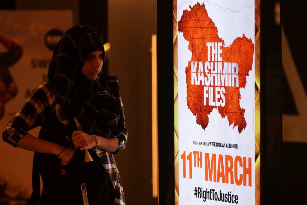 A woman walks past a poster for “The Kashmir Files” inside a cinema in Mumbai last week. Photo: Reuters