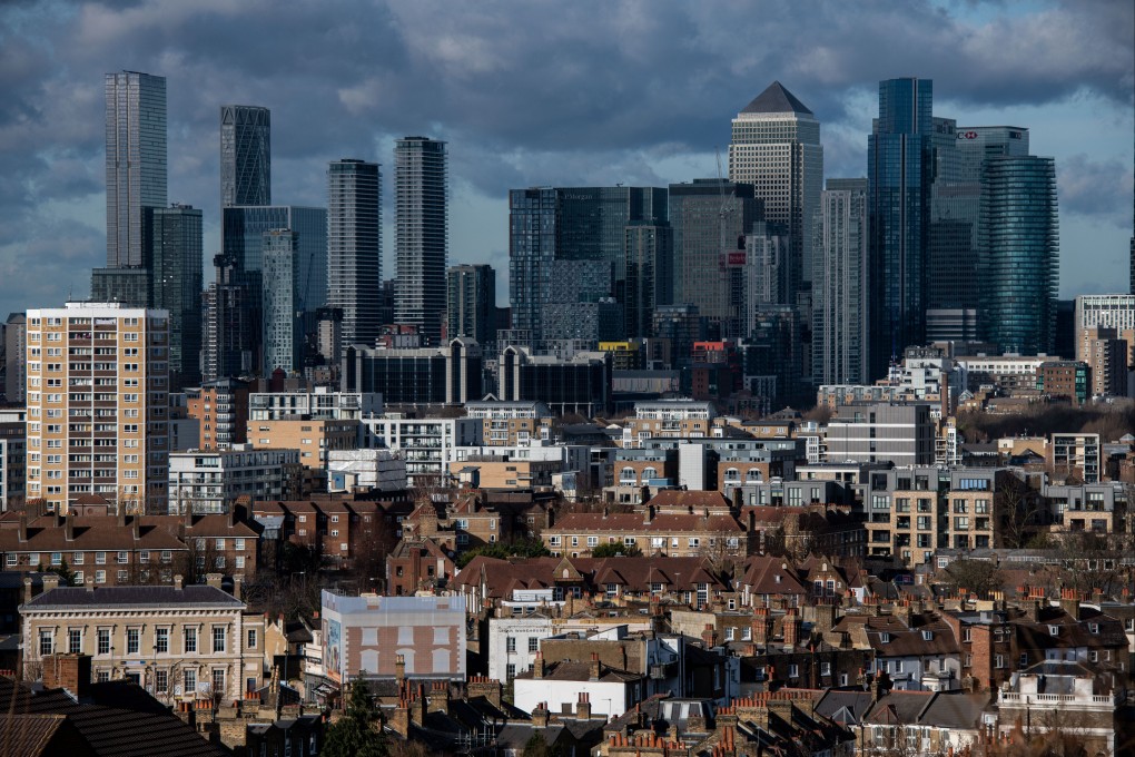 Skyscrapers in the Canary Wharf business, shopping and financial district on the skyline beyond residential property in London. Photo: Bloomberg
