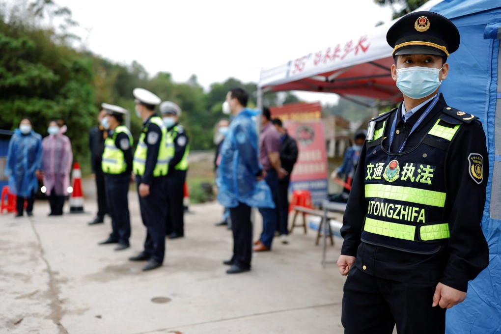 Police officers stand guard at a checkpoint at the entrance of Simen village near the site where a China Eastern Airlines Boeing 737-800 plane crashed on Monday. Photo: Reuters