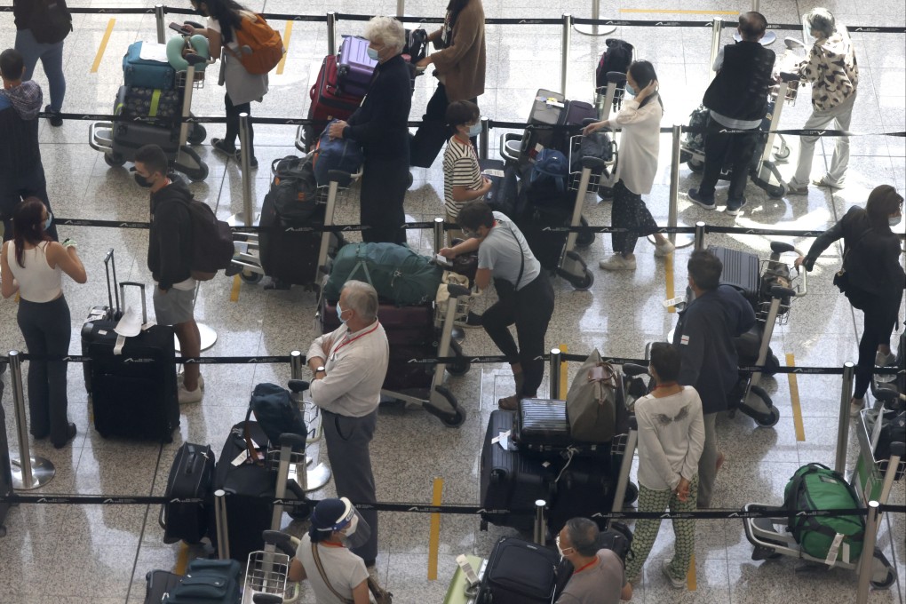 Inbound travellers at Hong Kong International Airport queue to be transported to quarantine hotels in the city. Photo: Nora Tam