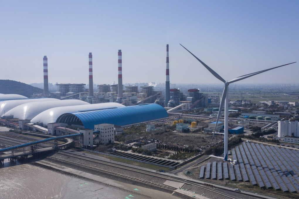 Photovoltaic panels are seen at a solar farm and wind turbines near a coal-fired power station in Jiaxing, in China’s Zhejiang province, on March 11. Photo: Bloomberg