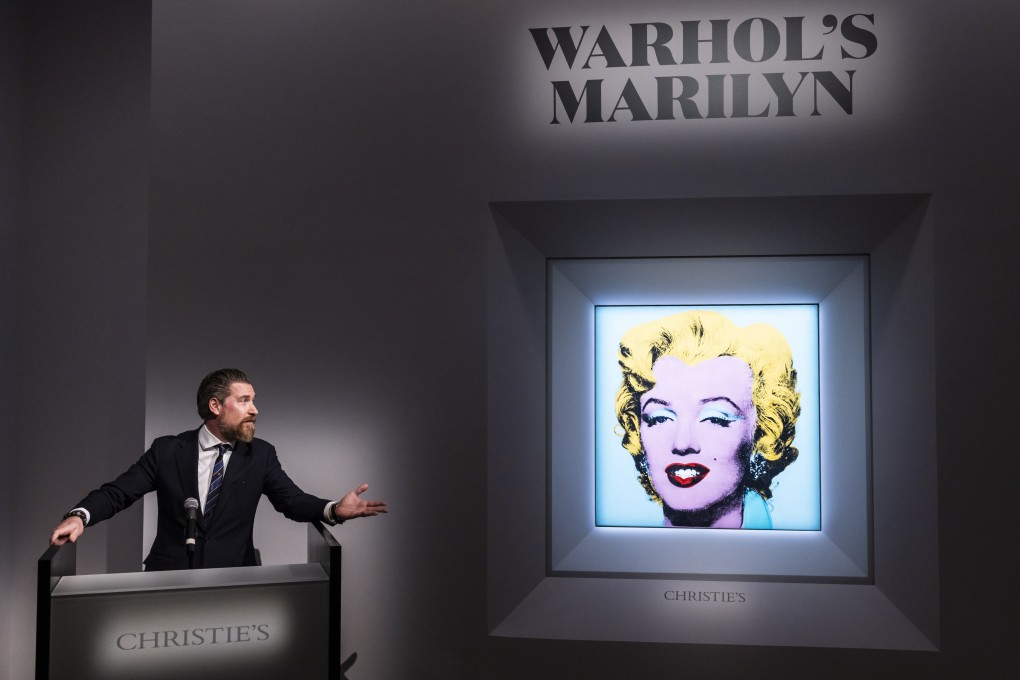 Alex Rotter, Christie’s chairman, in front of the 1964 painting “Shot Sage Blue Marilyn” by Andy Warhol at Christie’s in New York on March 21. Photo:  EPA-EFE