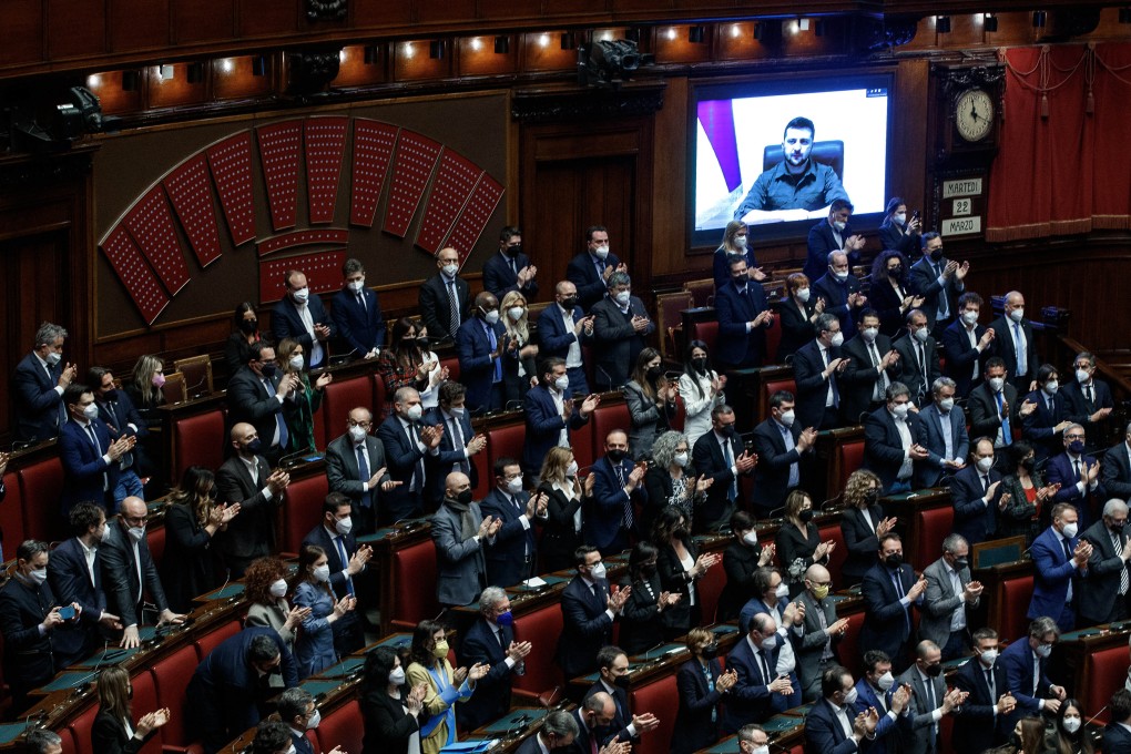Ukrainian President Volodymyr Zelensky (on screen) is applauded by Italian lawmakers while delivering a speech on Tuesday. Photo: dpa