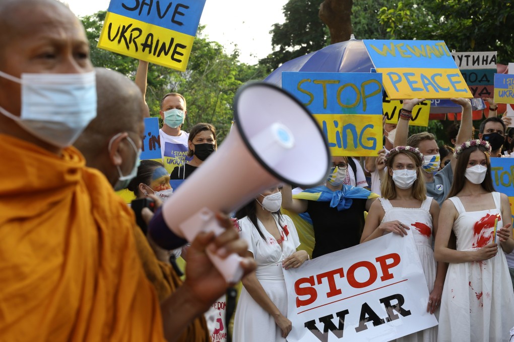 Thai Buddhist monks stand alongside Ukrainians living in Bangkok at a protest against Russia’s invasion of Ukraine this month. Photo: EPA