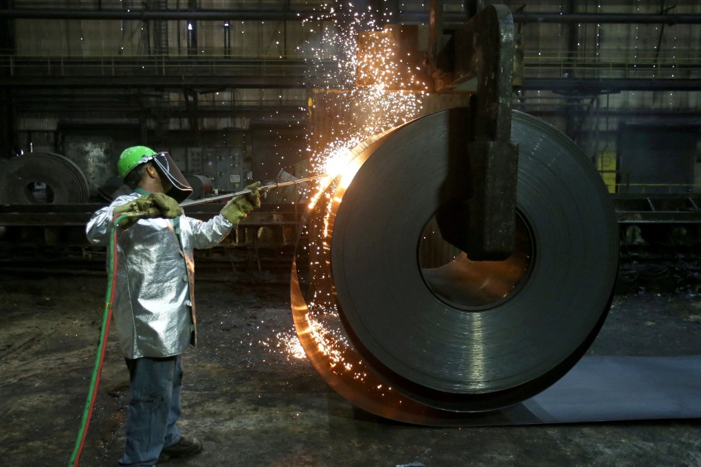 A worker cuts a piece from a steel coil at the Novolipetsk Steel PAO steel mill in Farrell, Pennsylvania, in March 2018. Photo: Reuters