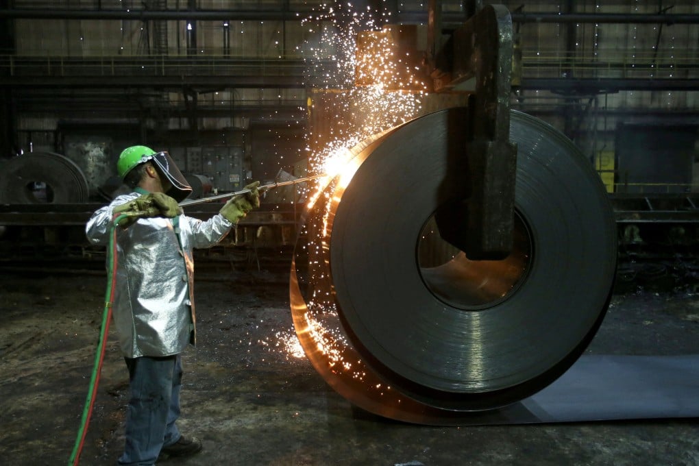 A worker cuts a piece from a steel coil at the Novolipetsk Steel PAO steel mill in Farrell, Pennsylvania, in March 2018. Photo: Reuters
