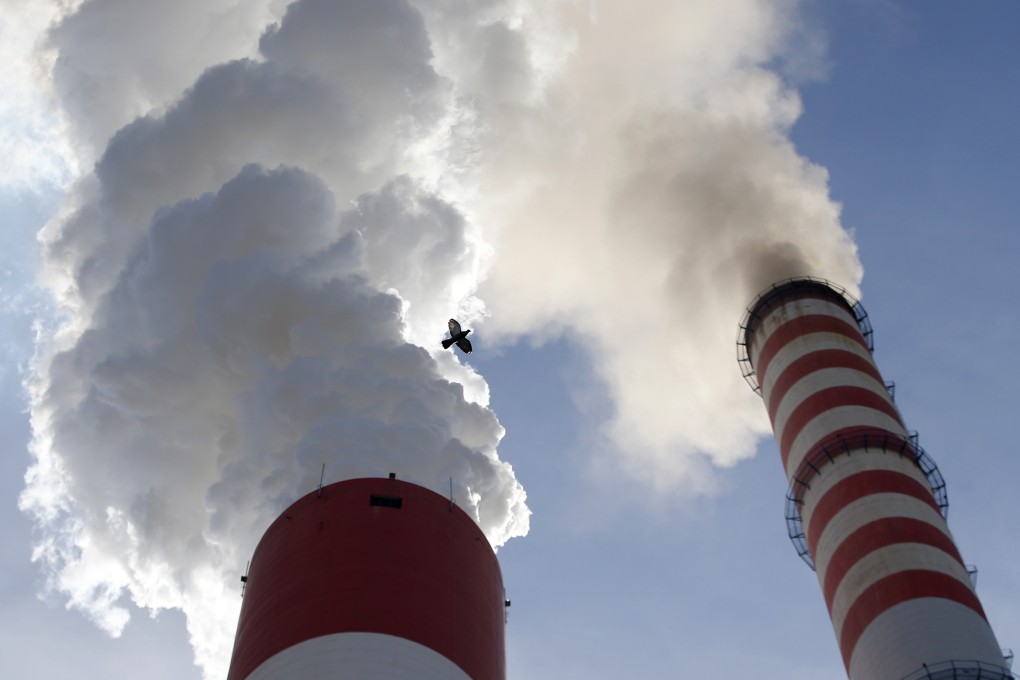 Smoke rises from the chimneys of a coal-fired power station. Photo: AP