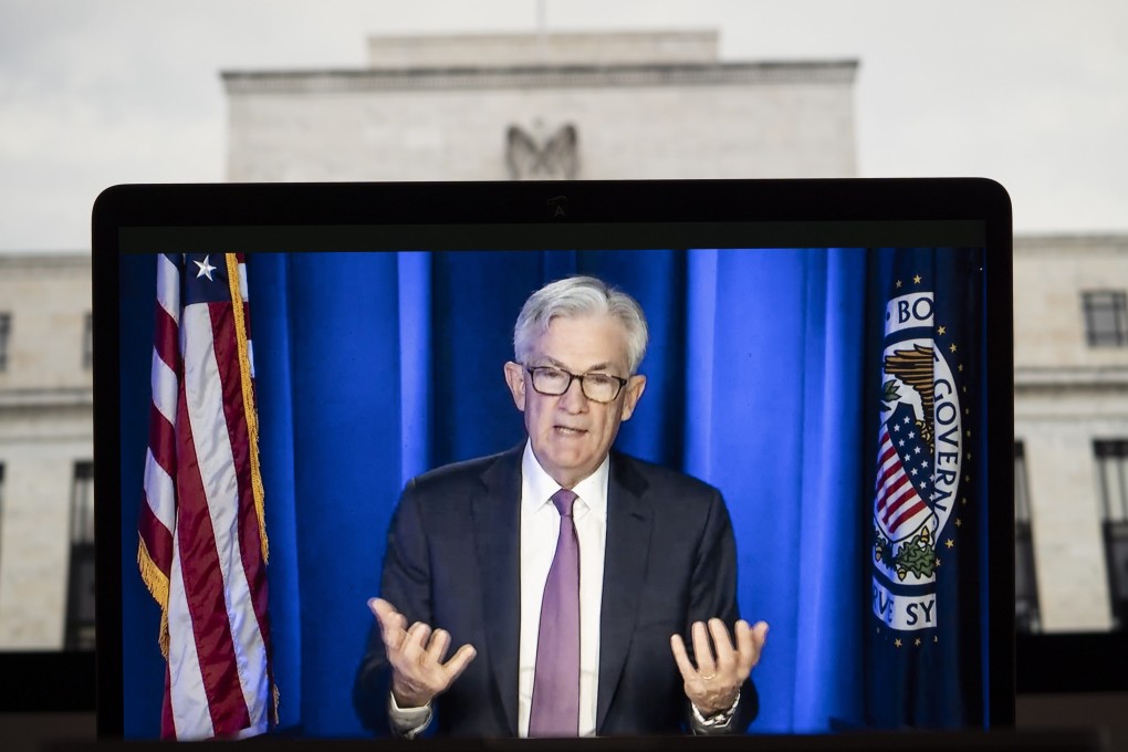 A screen shows US Federal Reserve chairman Jerome Powell speaking during a virtual press conference on March 16. The US central bank is moving towards policy tightening at the same time as China is pledging greater support to prop up economic growth. Photo: Xinhua