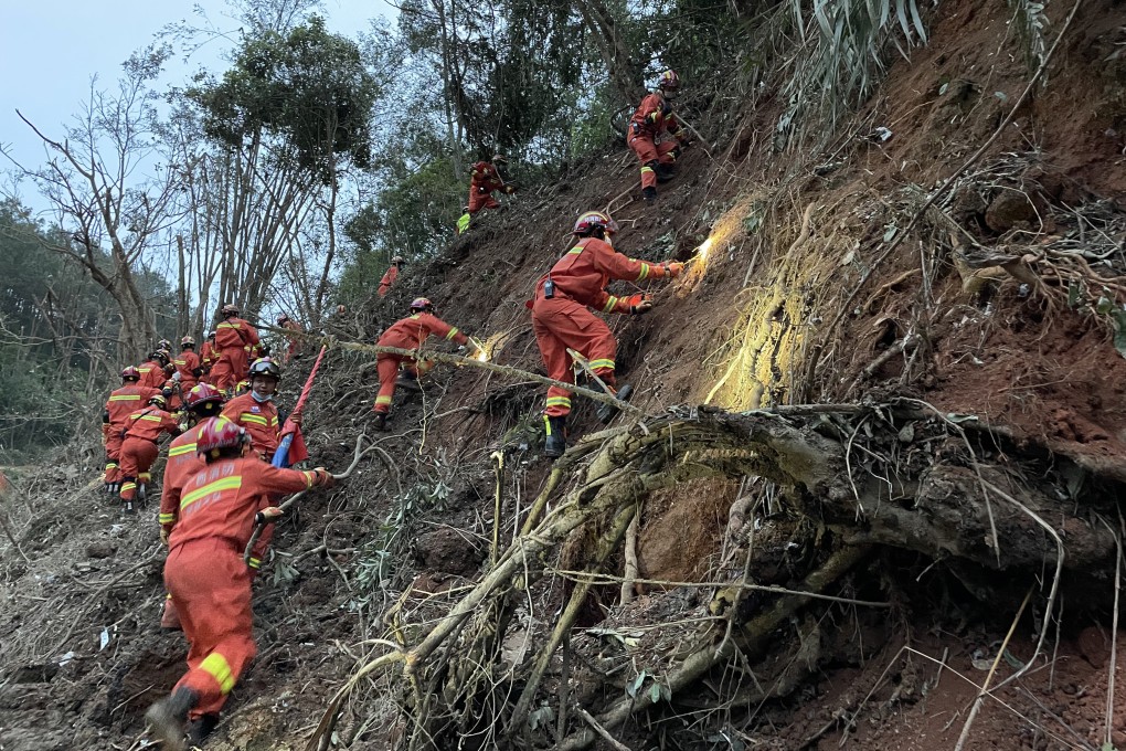 Rescuers search for the black boxes at the crash site in Guangxi. Photo: Xinhua