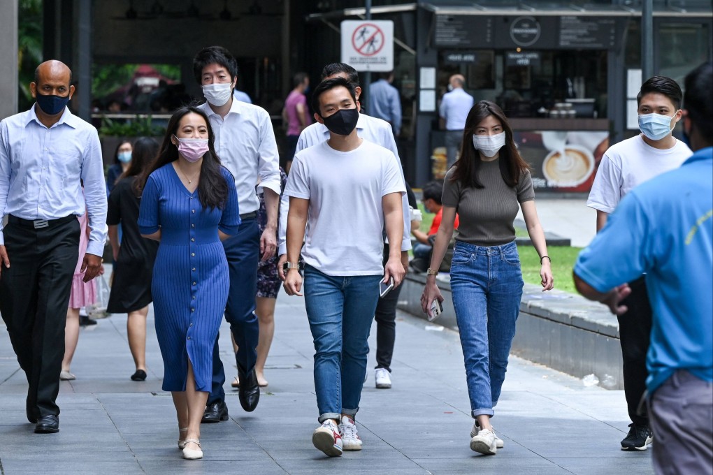 Office workers seen wearing marks on their lunch break in the Raffles Place financial business district of Singapore earlier this year. Photo: AFP