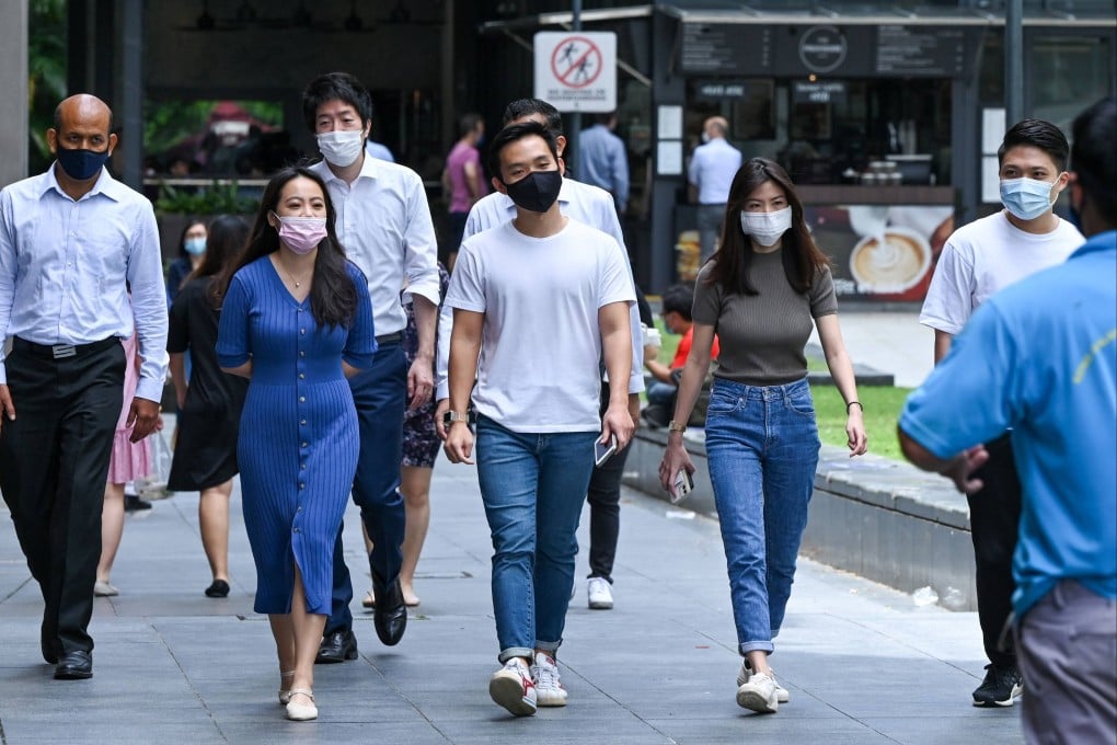 Office workers seen wearing marks on their lunch break in the Raffles Place financial business district of Singapore earlier this year. Photo: AFP