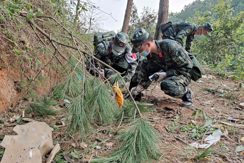 Police officers search the site of the China Eastern Airlines plane crash in southern Guangxi province. Photo: CNS