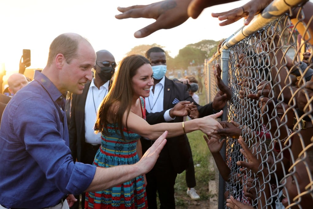 Prince William and Kate, Duchess of Cambridge shake hands with children during a visit to Trench Town in Kingston, Jamaica on Tuesday. Photo: Reuters