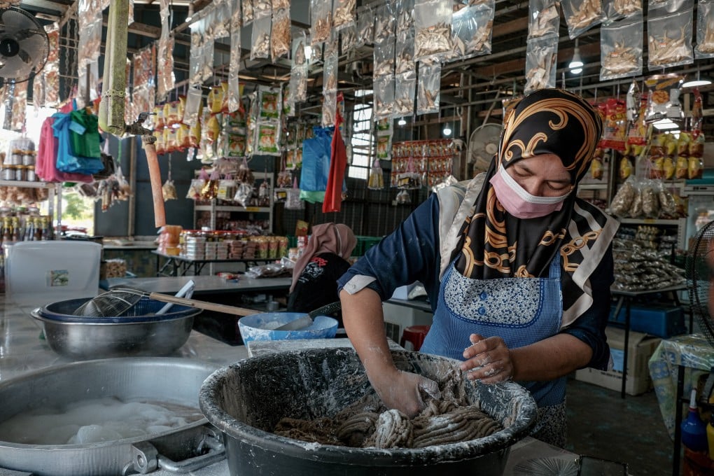 A worker prepares raw fish for cooking at a store in Terengganu. Photo: Bloomberg
