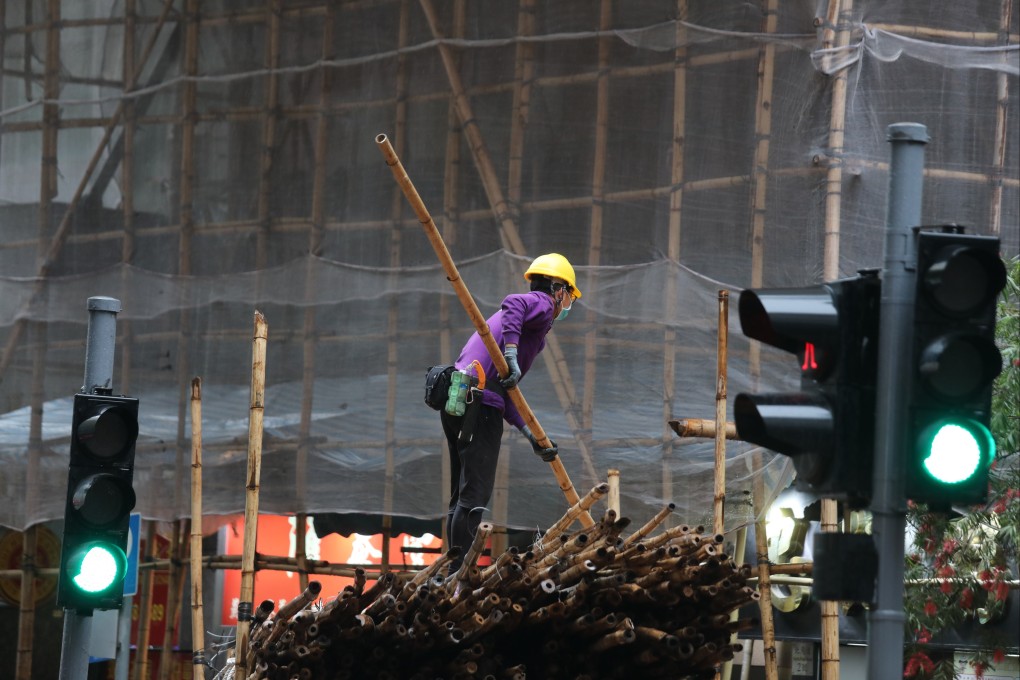 A worker at a construction site in North Point on March 23. Employees who cannot work from home have faced questions over sick leave and risk losing their jobs if they have to self-isolate during the pandemic. Photo: Xiaomei Chen