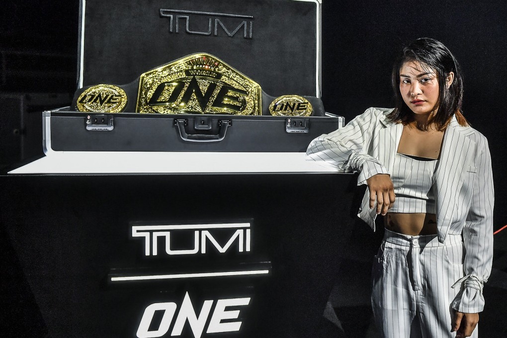 Stamp Fairtex stands next the the new ONE Championship world title – which she hopes to win at ONE X in Singapore. Photos: ONE Championship