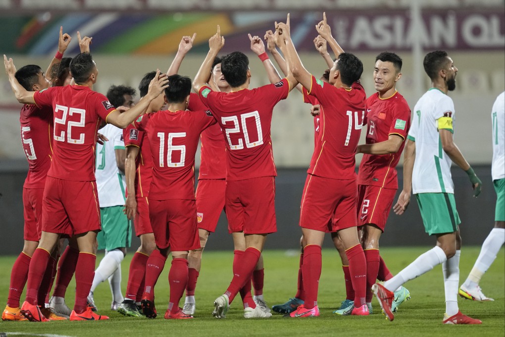 Chinese players celebrate after Zhu Chenjie (no. 20) scored the equaliser against Saudi Arabia and point to the sky to pay tribute to the recent air crash in Guangdong. Photo: AP