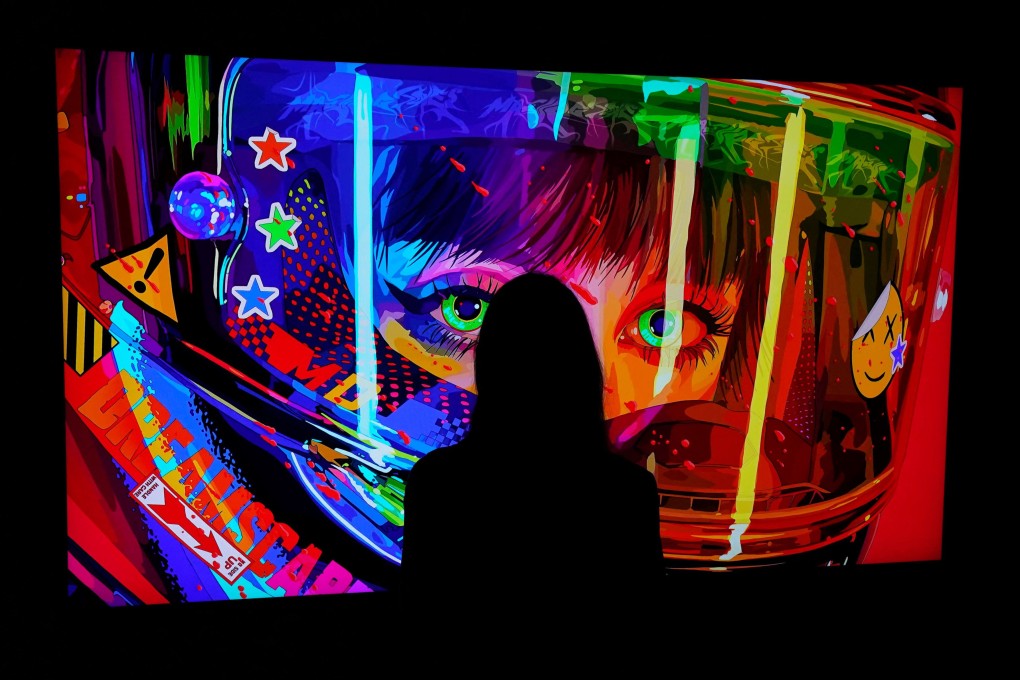 A woman looks at an NFT by Mad Dog Jones titled  “SHIFT//“ at the Natively Digital: A Curated NFT Sale Online Auction hosted by Sotheby’s, on June 4, 2021. Photo: AFP